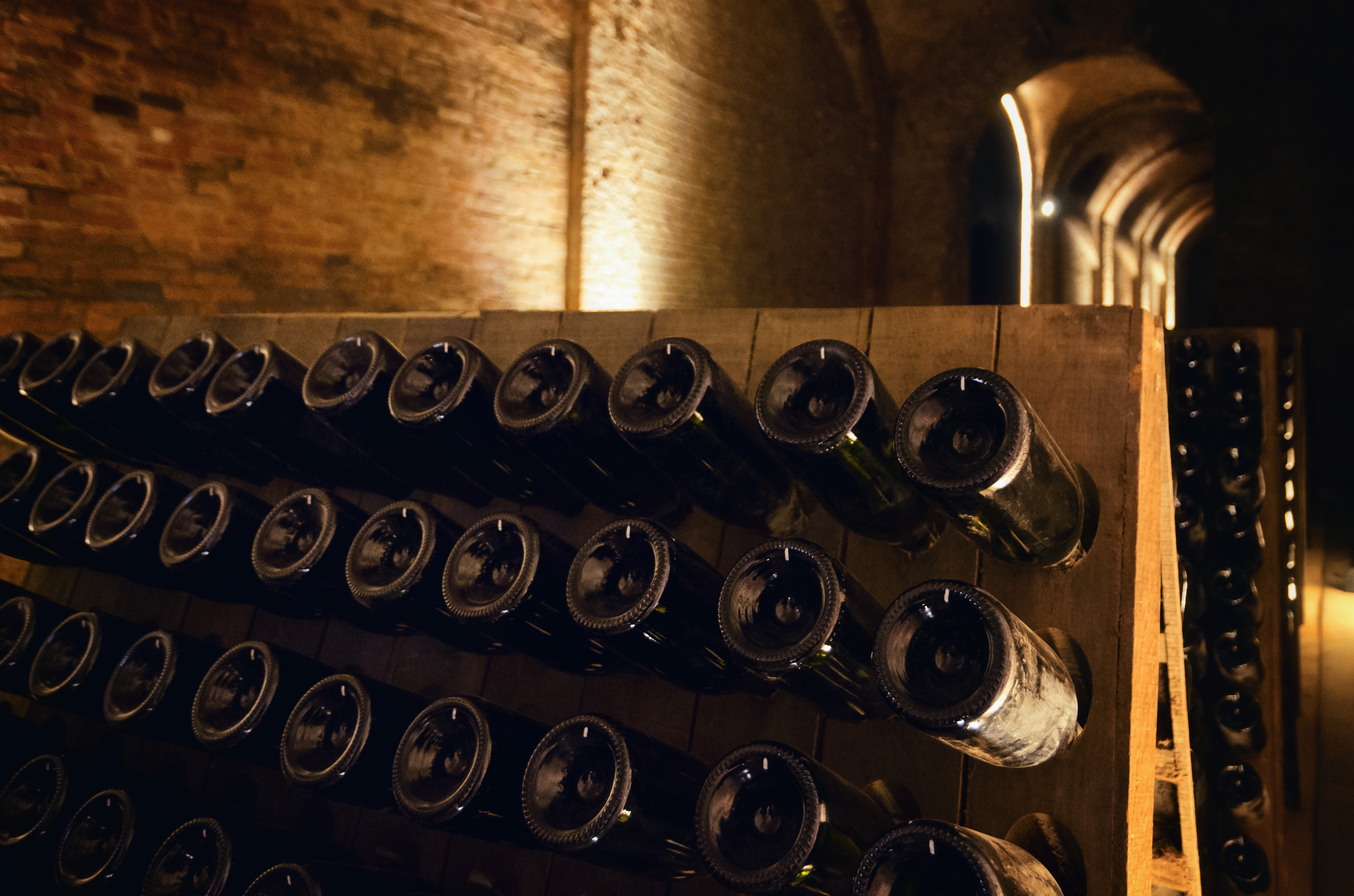 Pupitre and wine bottles inside an underground cellar