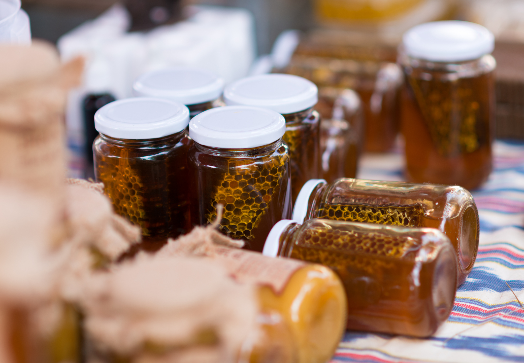 honey glasses with honeycomb at a market stall