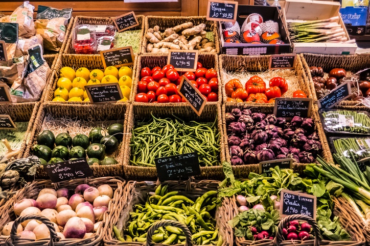 fruit and vegetables at the counter of a covered market