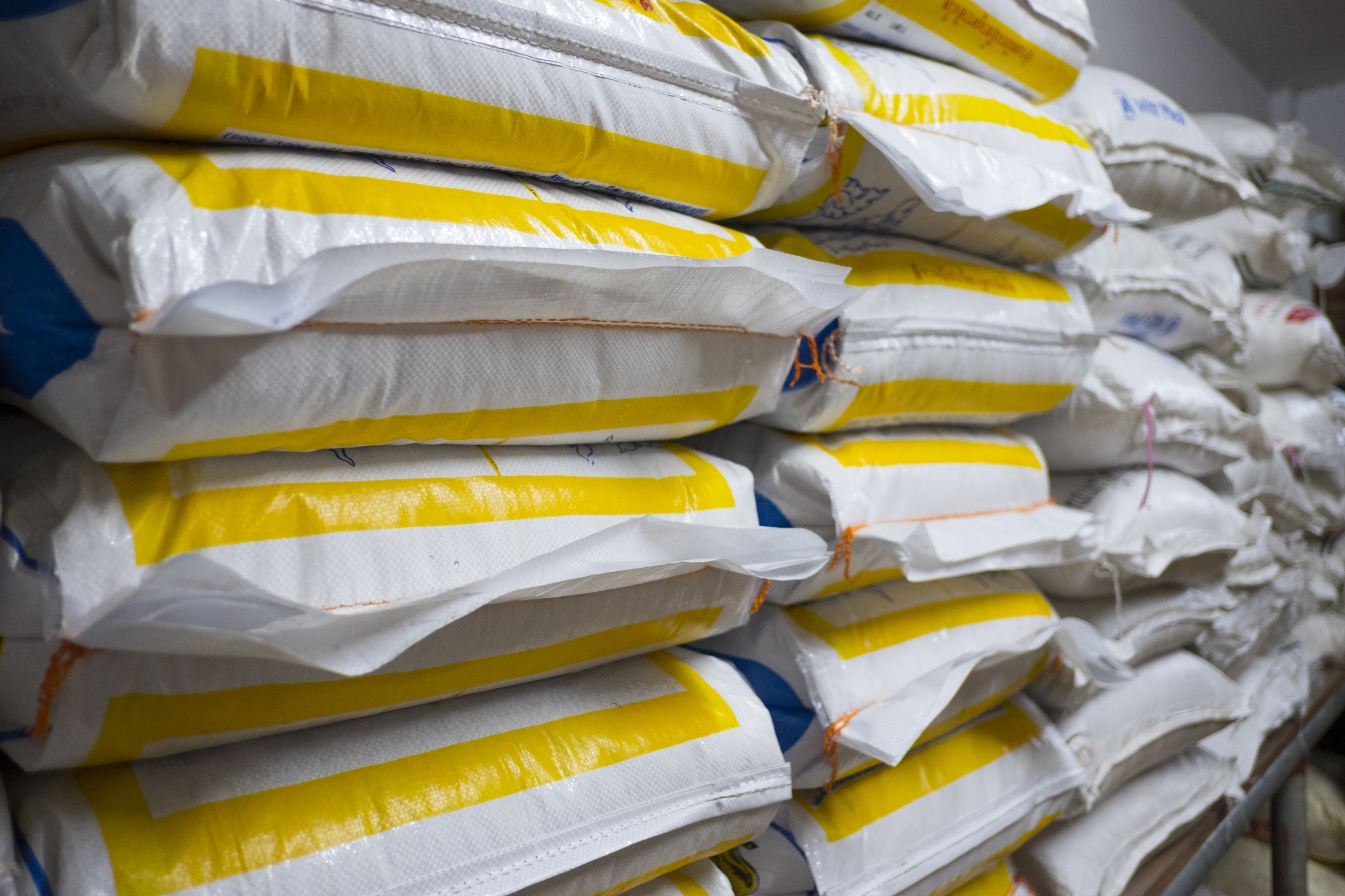 Pile of sack in warehouse. Background and texture of sack stack in warehouse.