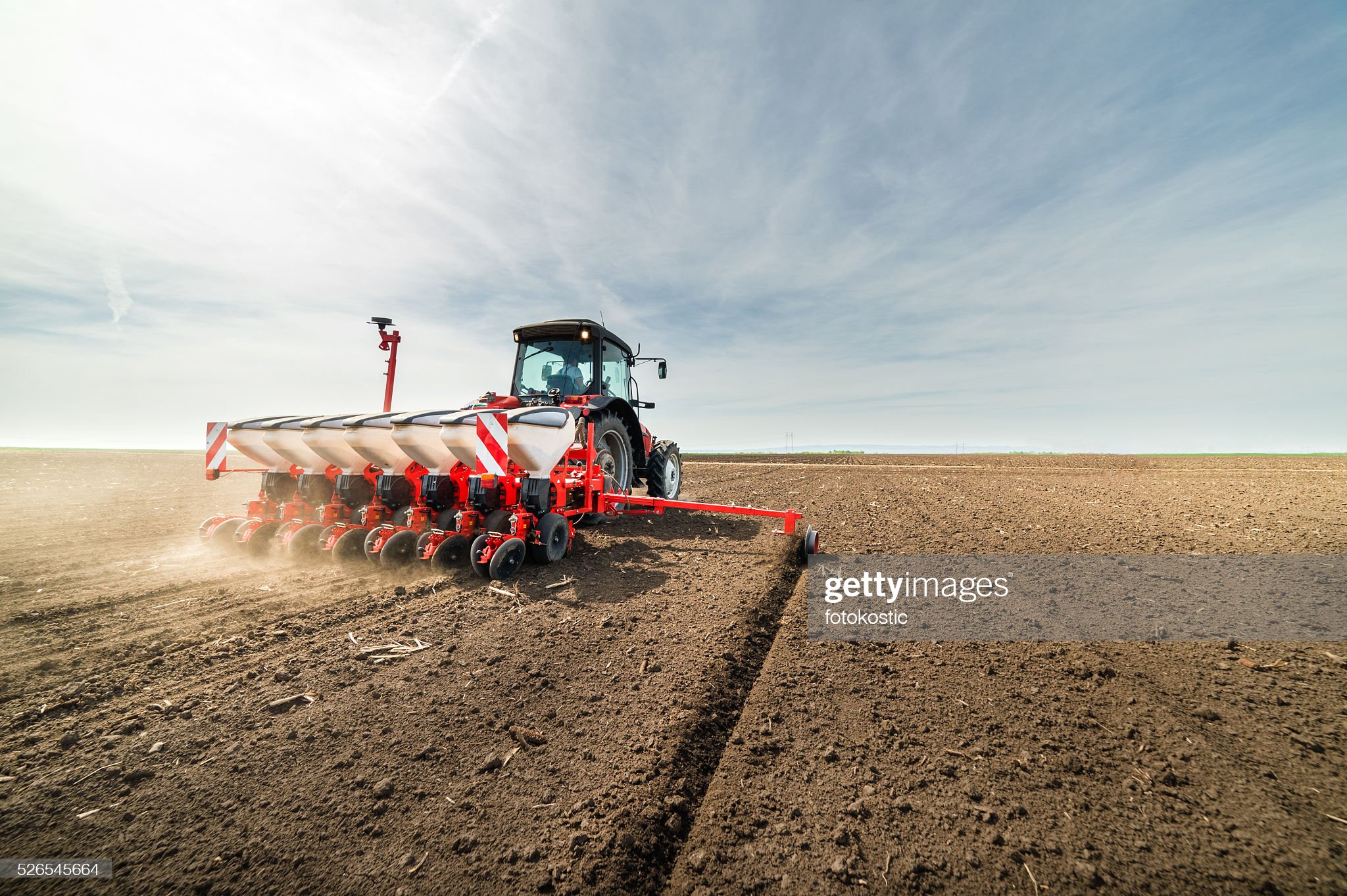 Farmer seeding crops at field