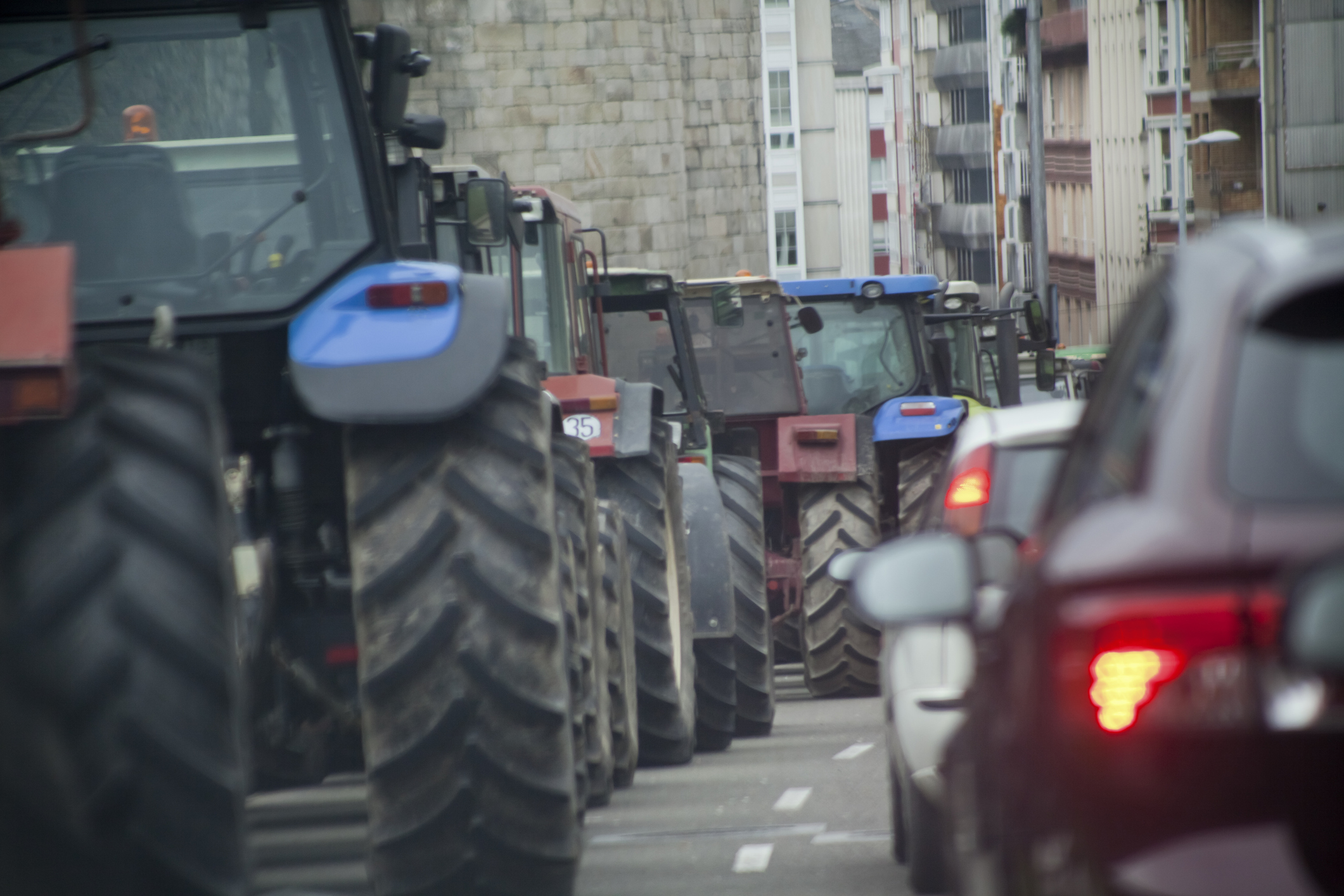 Traffic jam, tractors and cars.